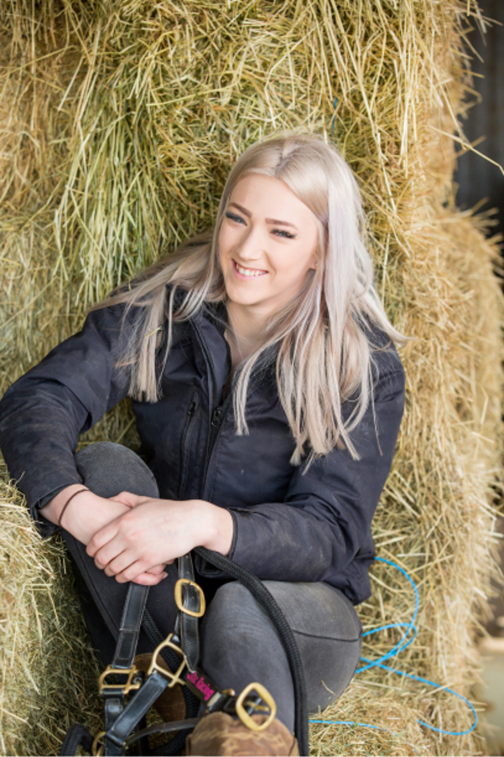 Chloe sitting on hay