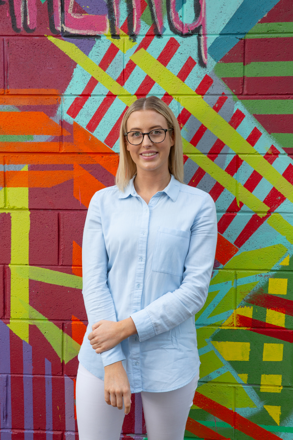 Hillary standing in front of modern street art