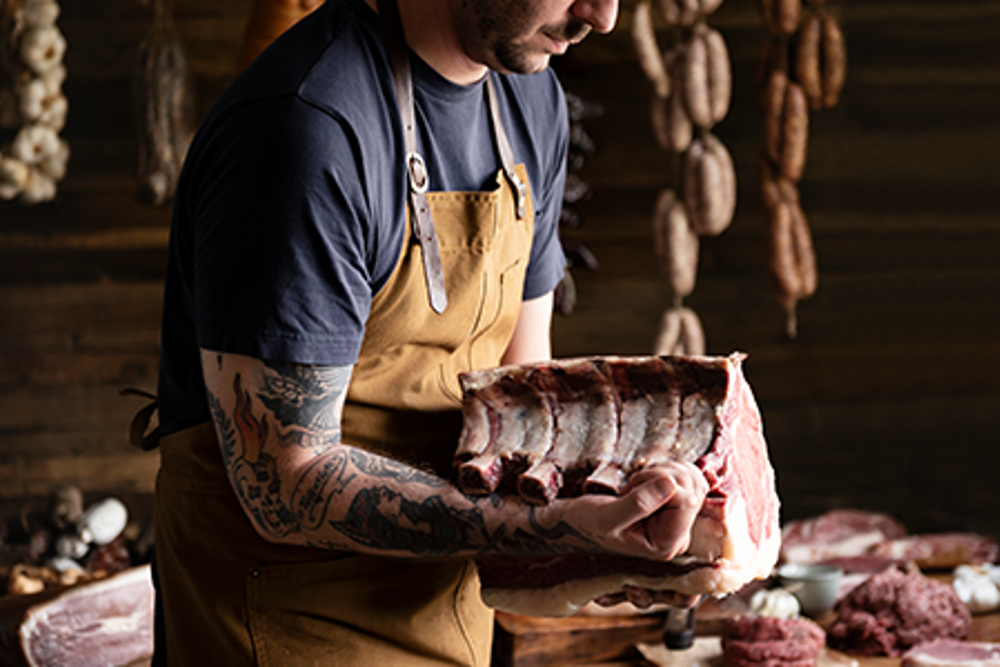 butcher holding meat