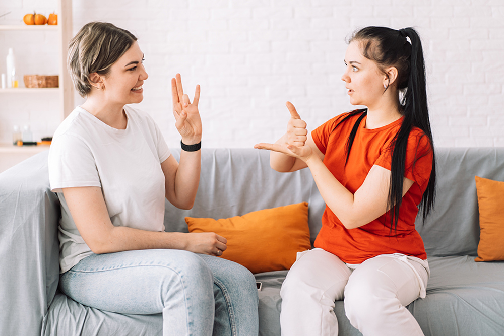 Girl asking for help in sign language.